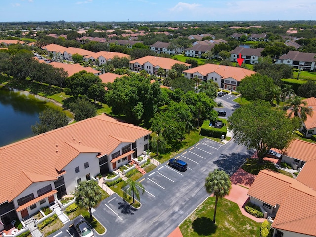 birds eye view of property featuring a water view and a residential view