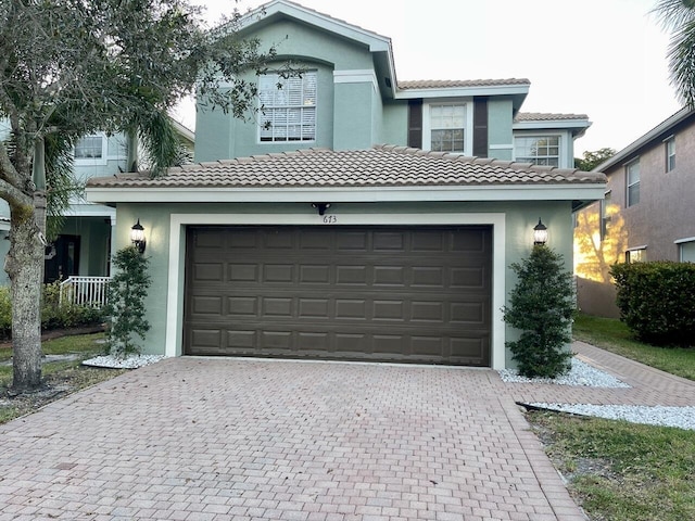 garage featuring decorative driveway