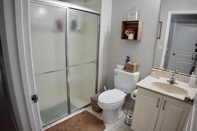 bathroom featuring a stall shower, tile patterned flooring, vanity, and toilet