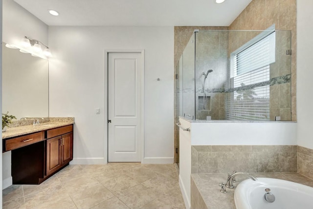 full bath with a stall shower, a garden tub, vanity, and baseboards