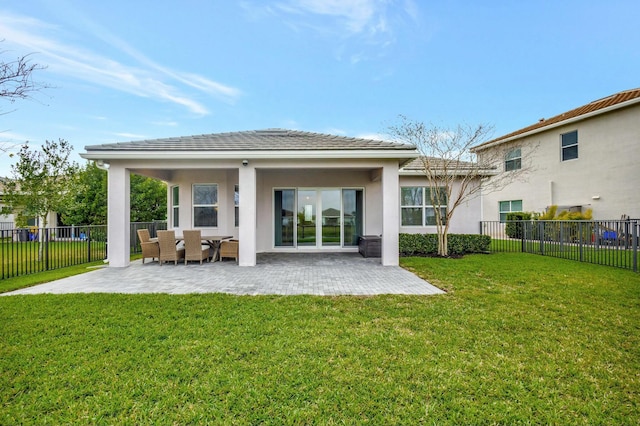 back of property featuring a patio area, fence, a lawn, and stucco siding