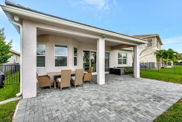 view of patio featuring fence and outdoor dining space