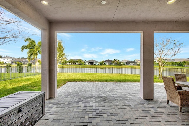 view of patio with a water view, a fenced backyard, and a residential view