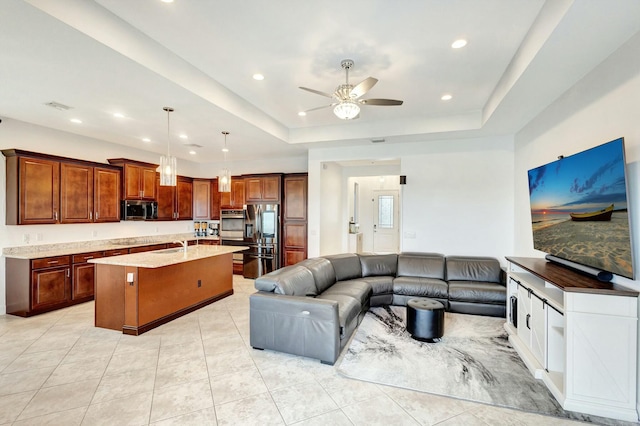 living area with a tray ceiling, visible vents, recessed lighting, and light tile patterned flooring