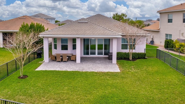 back of house with a fenced backyard, a patio, a lawn, and stucco siding