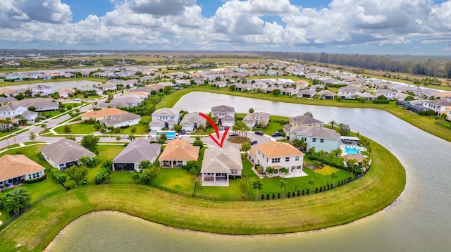 bird's eye view featuring a water view and a residential view