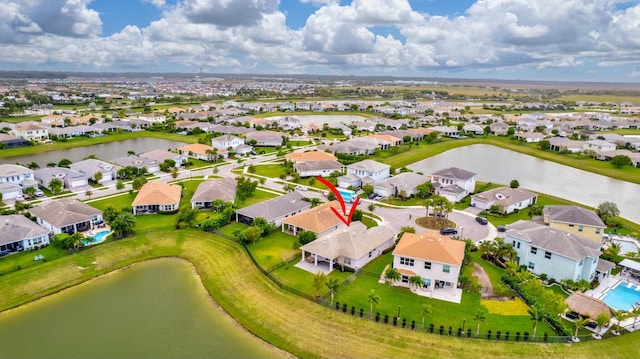 drone / aerial view featuring a water view and a residential view