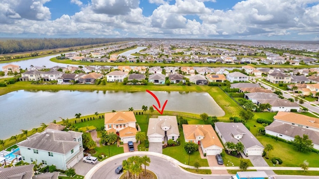 birds eye view of property with a residential view and a water view