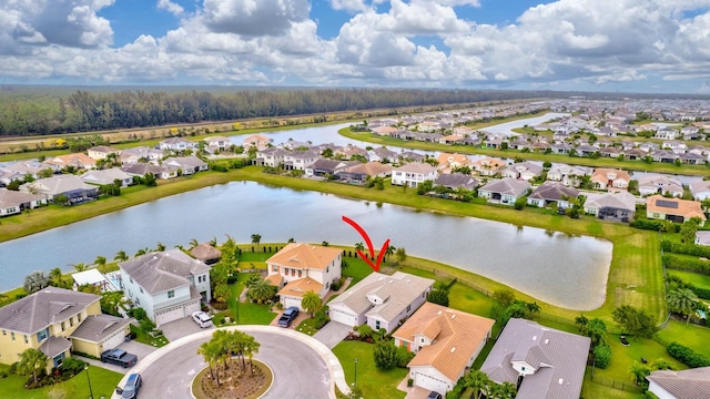 bird's eye view with a water view and a residential view