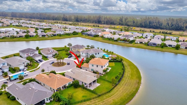 birds eye view of property with a water view and a residential view