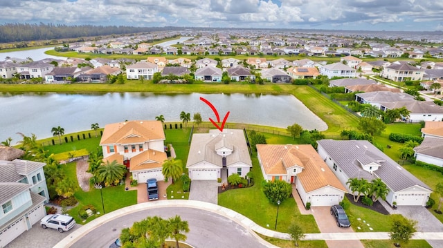 drone / aerial view featuring a water view and a residential view