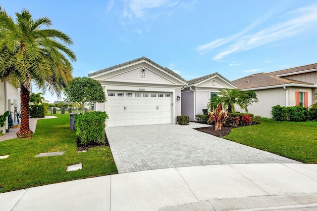 ranch-style home featuring a garage, a front yard, decorative driveway, and stucco siding