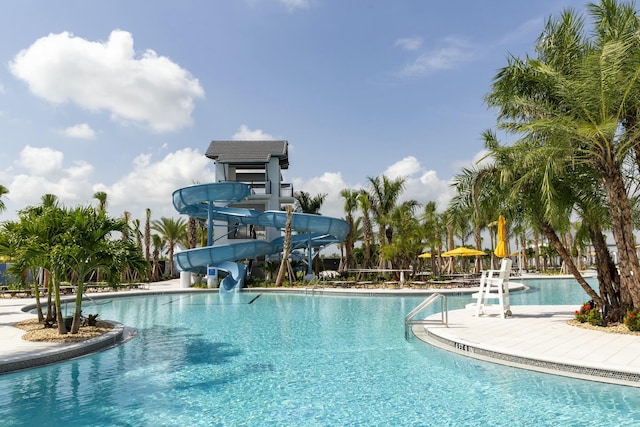 community pool featuring a water slide