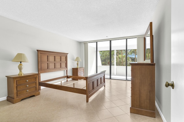 6620 Boca De Mar Dr Unit 105, Boca Raton, FL 33433 - bedroom featuring floor to ceiling windows, a textured ceiling, and baseboards