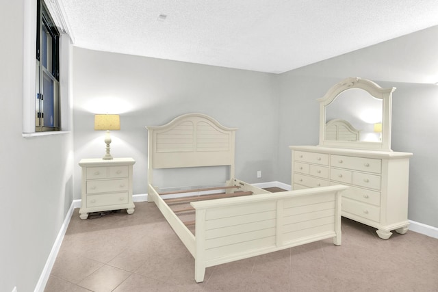 6620 Boca De Mar Dr Unit 105, Boca Raton, FL 33433 - bedroom featuring light tile patterned floors, baseboards, and a textured ceiling