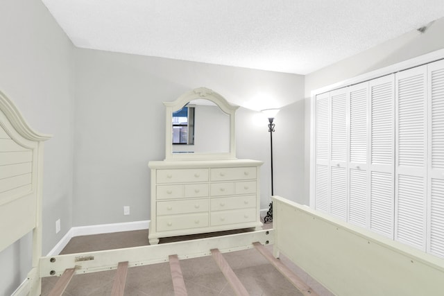 6620 Boca De Mar Dr Unit 105, Boca Raton, FL 33433 - bedroom featuring baseboards, a textured ceiling, and a closet