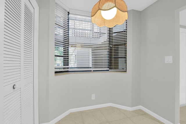 6620 Boca De Mar Dr Unit 105, Boca Raton, FL 33433 - unfurnished dining area featuring baseboards, a healthy amount of sunlight, and tile patterned flooring