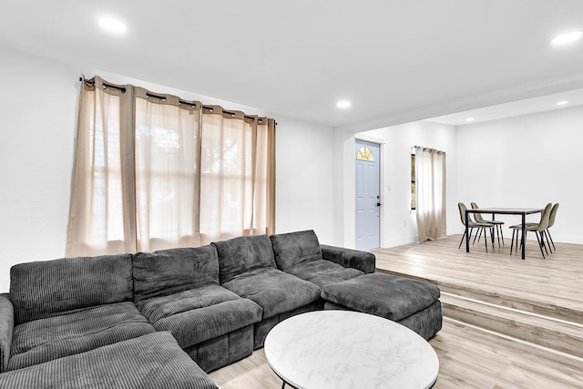 living room with light wood finished floors and recessed lighting