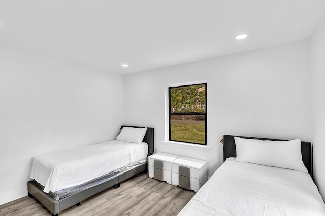 bedroom featuring wood finished floors and recessed lighting