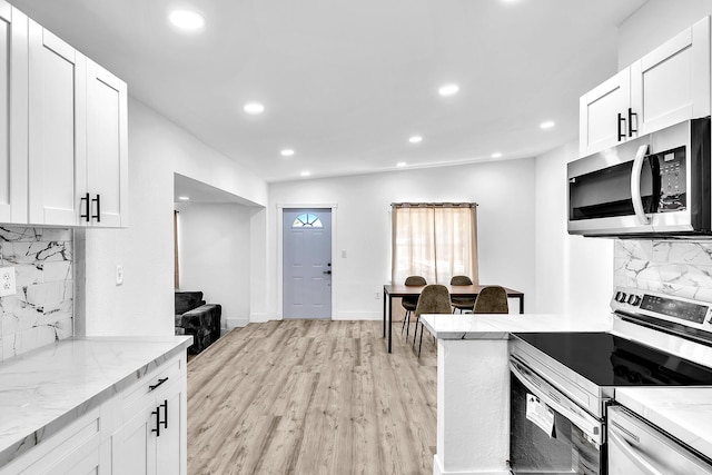 kitchen featuring stainless steel appliances, light wood-type flooring, recessed lighting, and light stone countertops