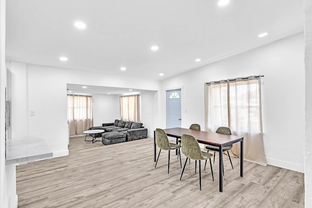 dining room featuring recessed lighting, baseboards, and light wood finished floors