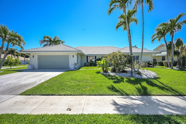 view of front of property with driveway, a front yard, and an attached garage