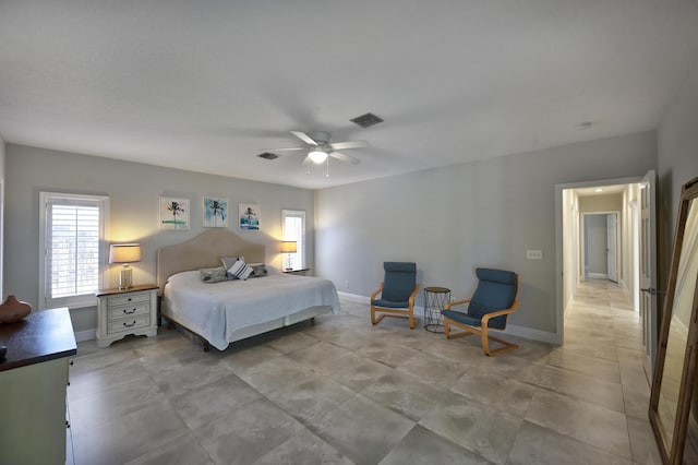 bedroom with multiple windows, visible vents, baseboards, and ceiling fan