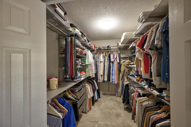 walk in closet with tile patterned flooring