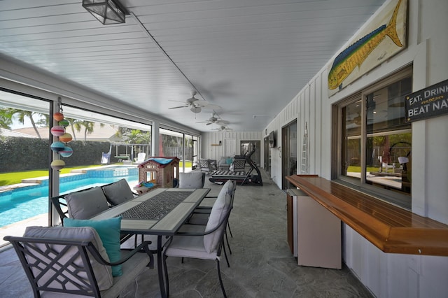 sunroom with a ceiling fan