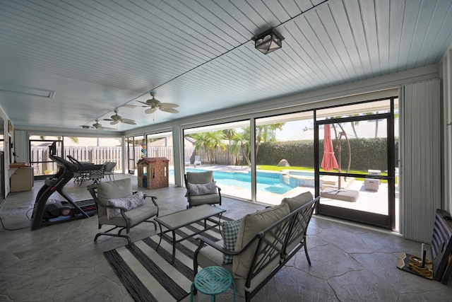 sunroom featuring ceiling fan