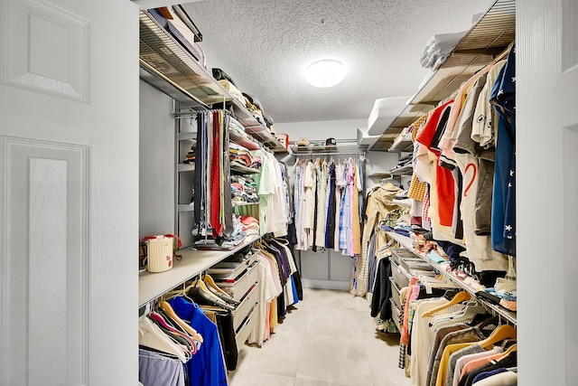 spacious closet with tile patterned floors