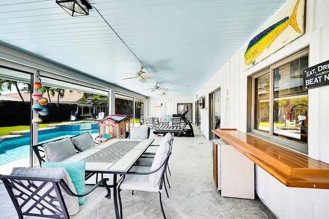 sunroom with a ceiling fan