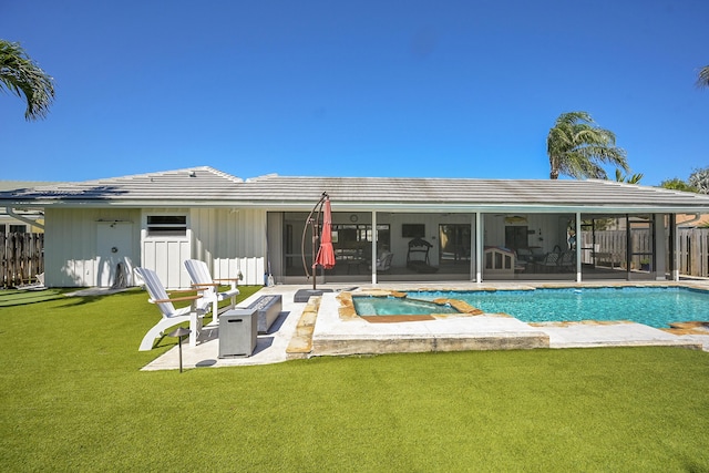 back of property featuring fence, a yard, an outdoor pool, a sunroom, and a fire pit