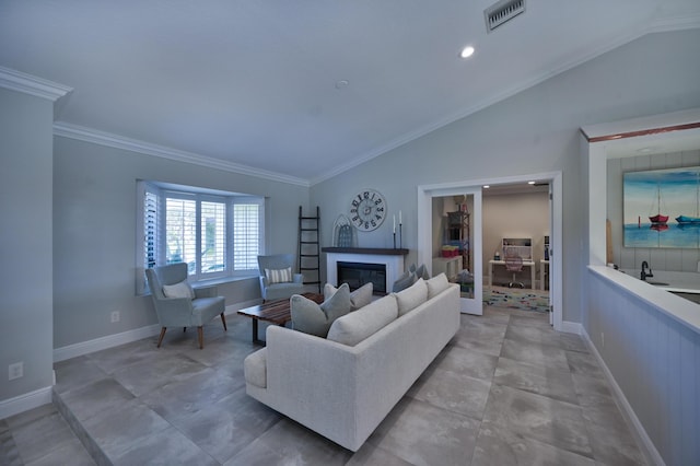 living area with visible vents, crown molding, a glass covered fireplace, and vaulted ceiling