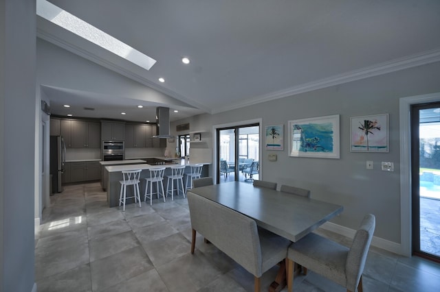 dining room featuring light tile patterned floors, baseboards, recessed lighting, crown molding, and lofted ceiling with skylight