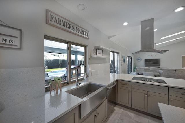 kitchen with gray cabinets, island exhaust hood, a sink, black electric cooktop, and vaulted ceiling