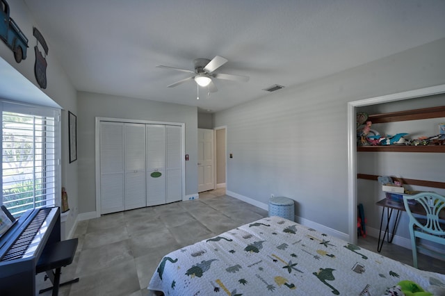 bedroom featuring baseboards, visible vents, a closet, and ceiling fan