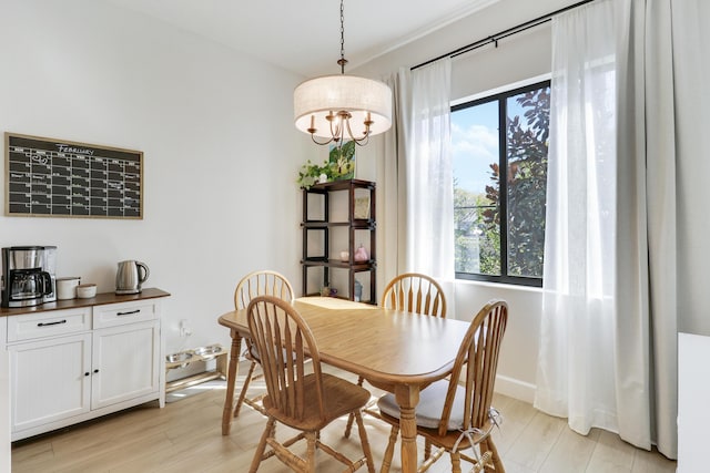 dining room featuring light wood-style flooring and baseboards