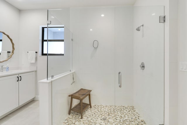 bathroom with tile patterned flooring, a shower stall, and vanity