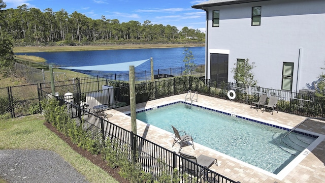 pool with a water view, a patio, and fence