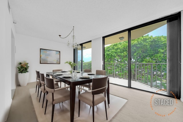 dining area featuring expansive windows and a notable chandelier