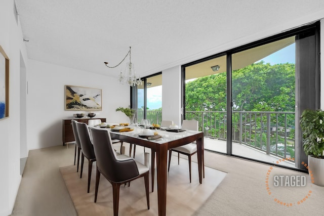 dining area featuring an inviting chandelier and floor to ceiling windows