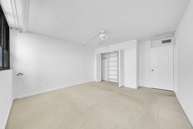 unfurnished bedroom with visible vents, carpet flooring, ceiling fan, a textured ceiling, and baseboards