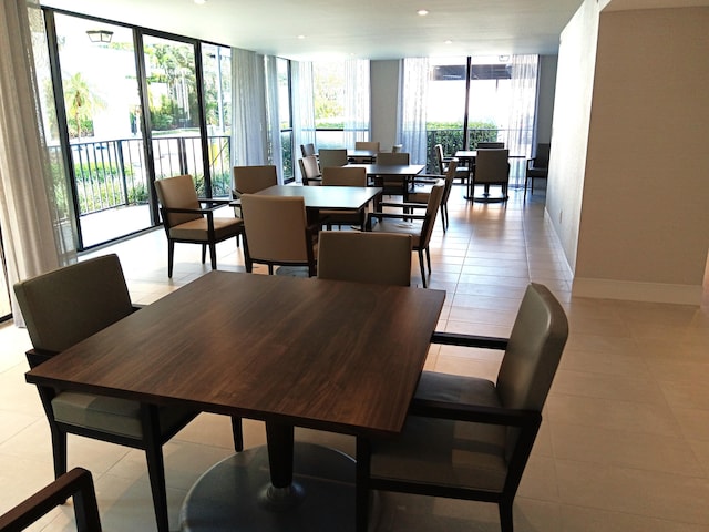 dining space featuring a wealth of natural light, expansive windows, and baseboards