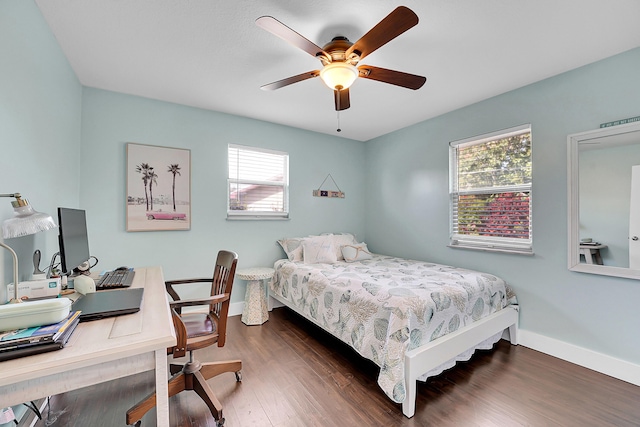 bedroom featuring a ceiling fan, wood finished floors, and baseboards