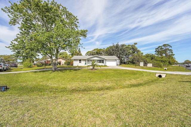 ranch-style house with an attached garage, concrete driveway, and a front yard