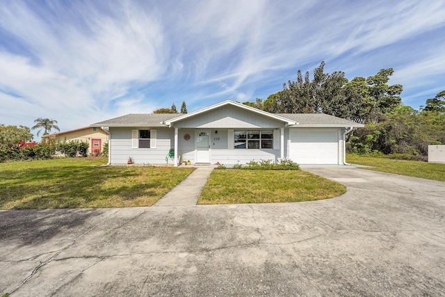 single story home featuring a front lawn, concrete driveway, and a garage