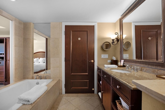 ensuite bathroom featuring a garden tub, tile patterned flooring, connected bathroom, tile walls, and vanity