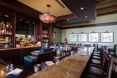 bar featuring hanging light fixtures and a dry bar