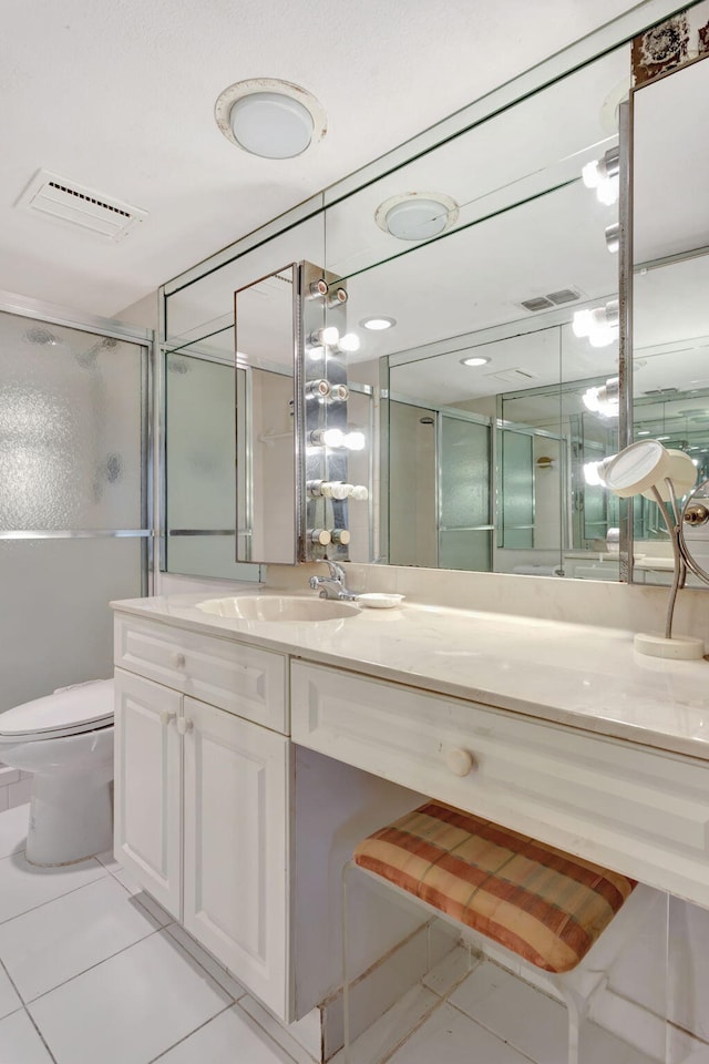 bathroom featuring a stall shower, tile patterned flooring, visible vents, and toilet